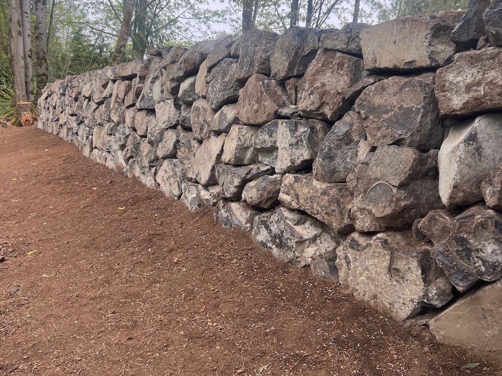 Rock retaining wall installation.