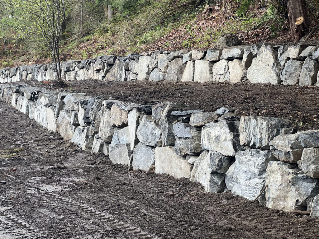 Issaquah WA large stone retaining wall hillside build