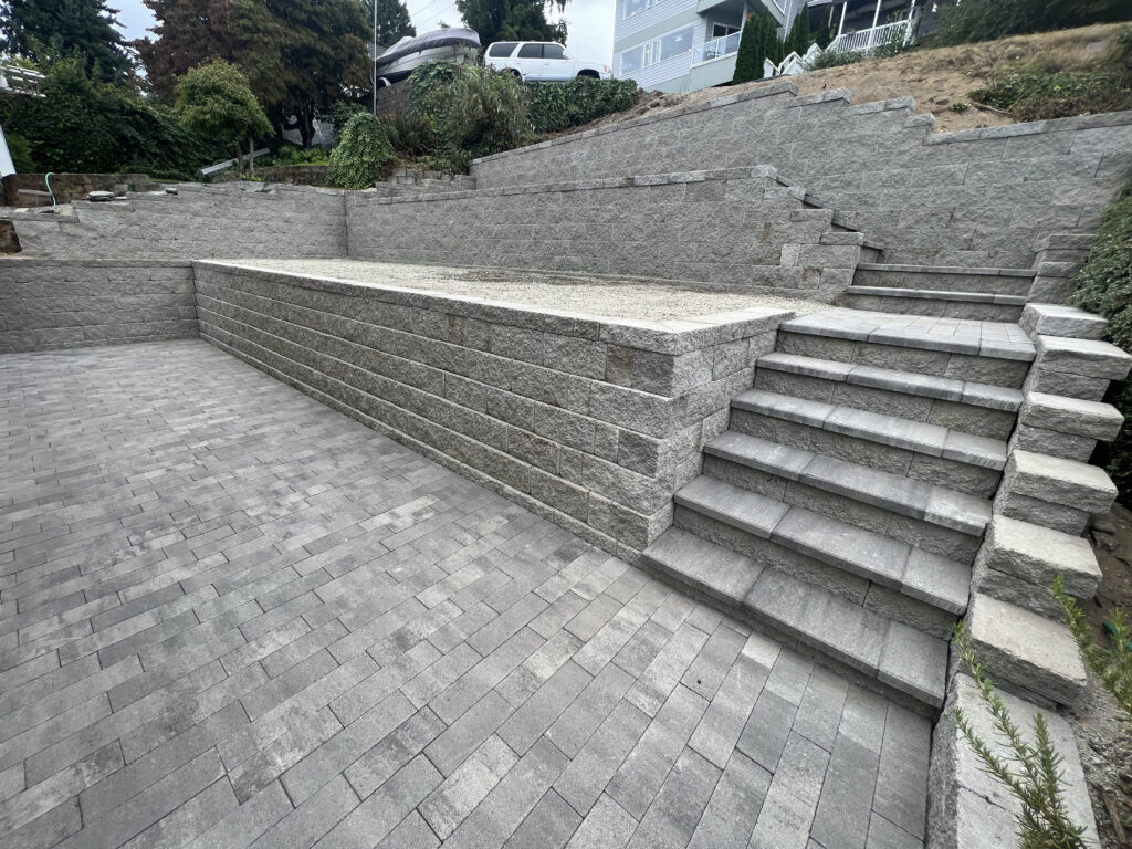 Tacoma WA tiered block retaining wall with stairs and paver patio installation