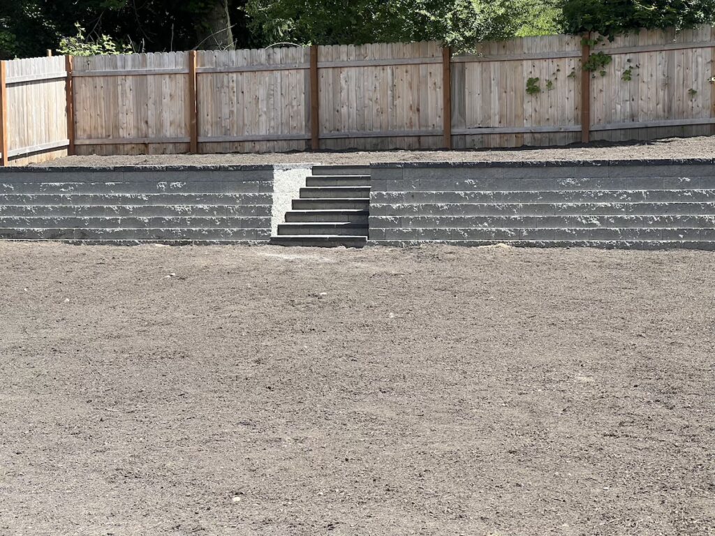 Spacious yard created by building a block wall.