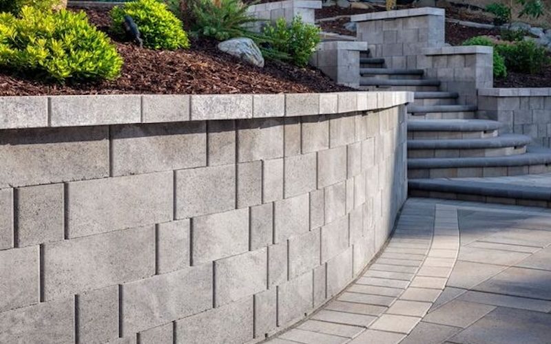 Block retaining wall with curved design.